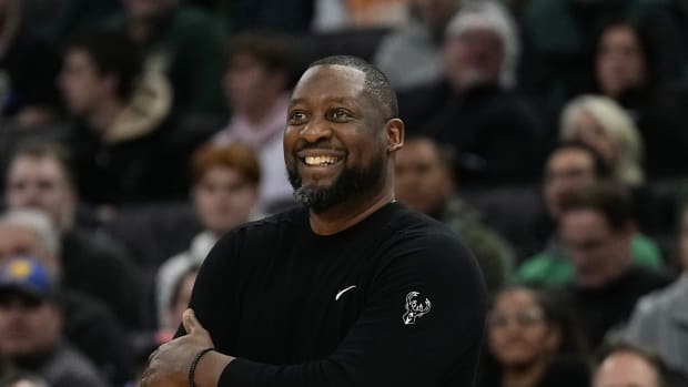 Milwaukee Bucks head coach Adrian Griffin smiles 